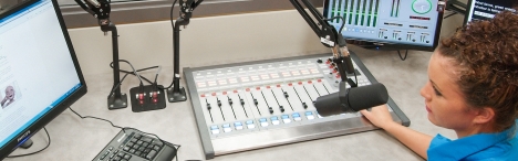 Student working behind the scenes of a broadcast