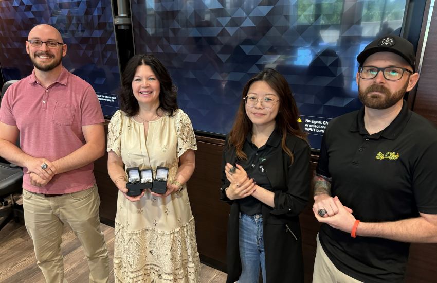 Esports staff with President Patti France holding rings