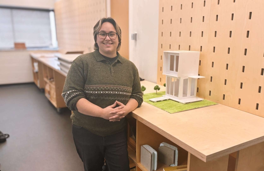 Woodworking student Sadie Alejandria stands in a classroom