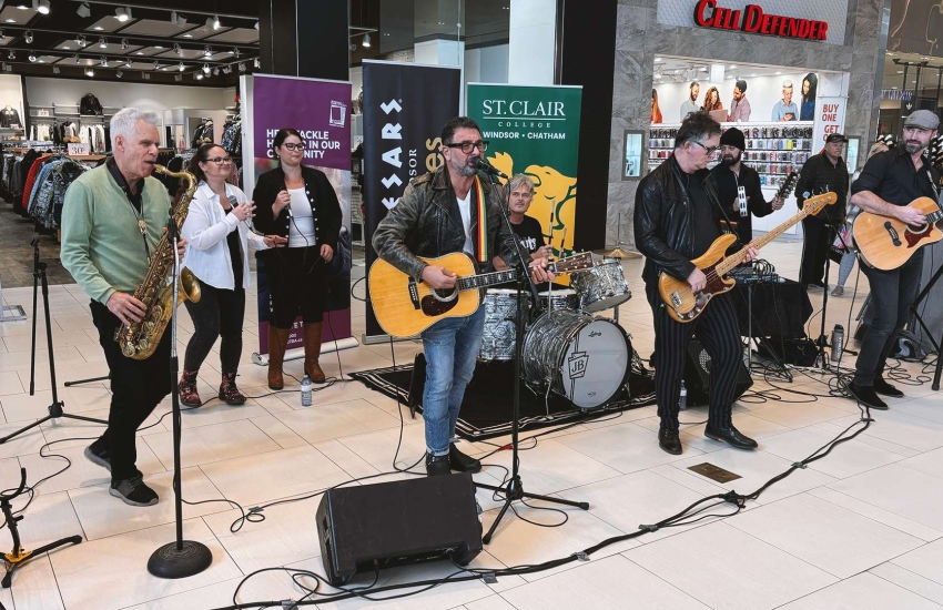 Members of the S'Aints Band play holiday tunes at Devonshire Mall