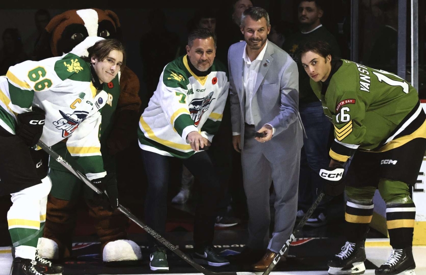 Players for the Battalion and Spitfires face off as St. Clair President Michael Silvaggi and OHL Commissioner Bryan Crawford drop the puck