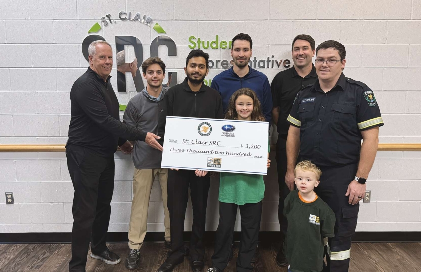 Members of the SRC Food Bank, Saints Nation Swim and Run race co-chairs, and the College's Alumni Association gather for a cheque presentation