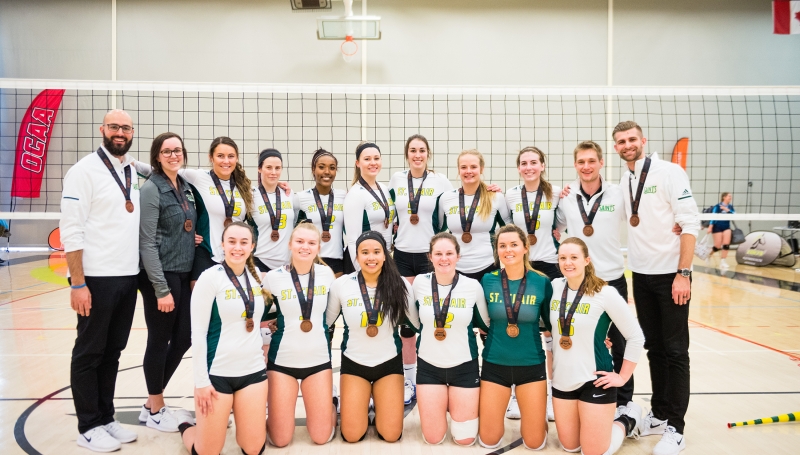 Womens Volleyball team photo with bronze medals