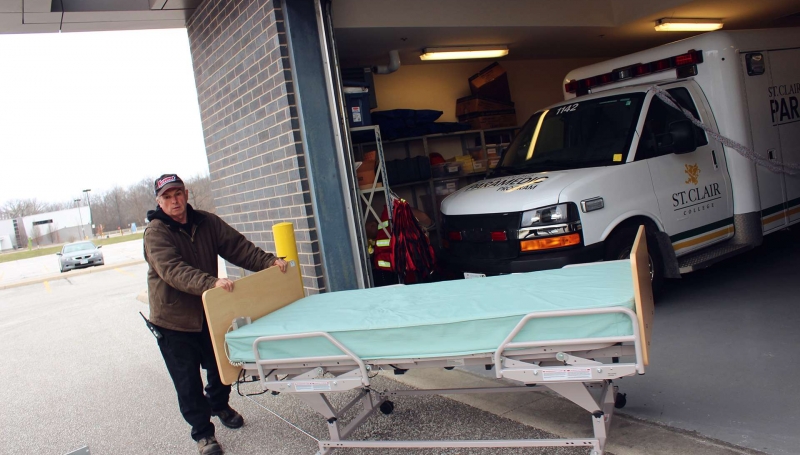 Dave Purdie pushes out an extra hospital bed.