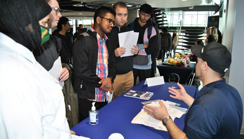 Business and IT students at info table