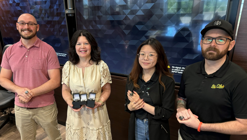 Esports staff with President Patti France holding rings