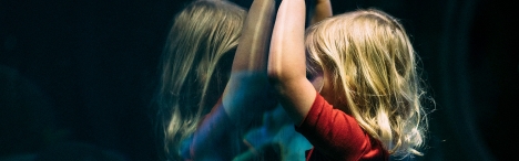 Child with face against glass.