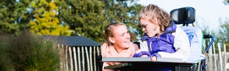 Edudcational support student helping a younger student with exceptionalitites.