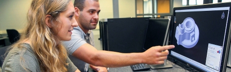 2 students designing mould on computer